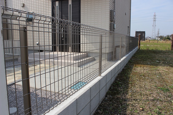 熊谷市の白い塗り壁とスタイリッシュなカーポートが印象的なセミクローズ外構のお隣との境界フェンス